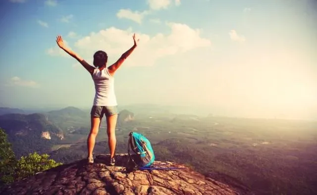 A woman completing the hike on a mountain